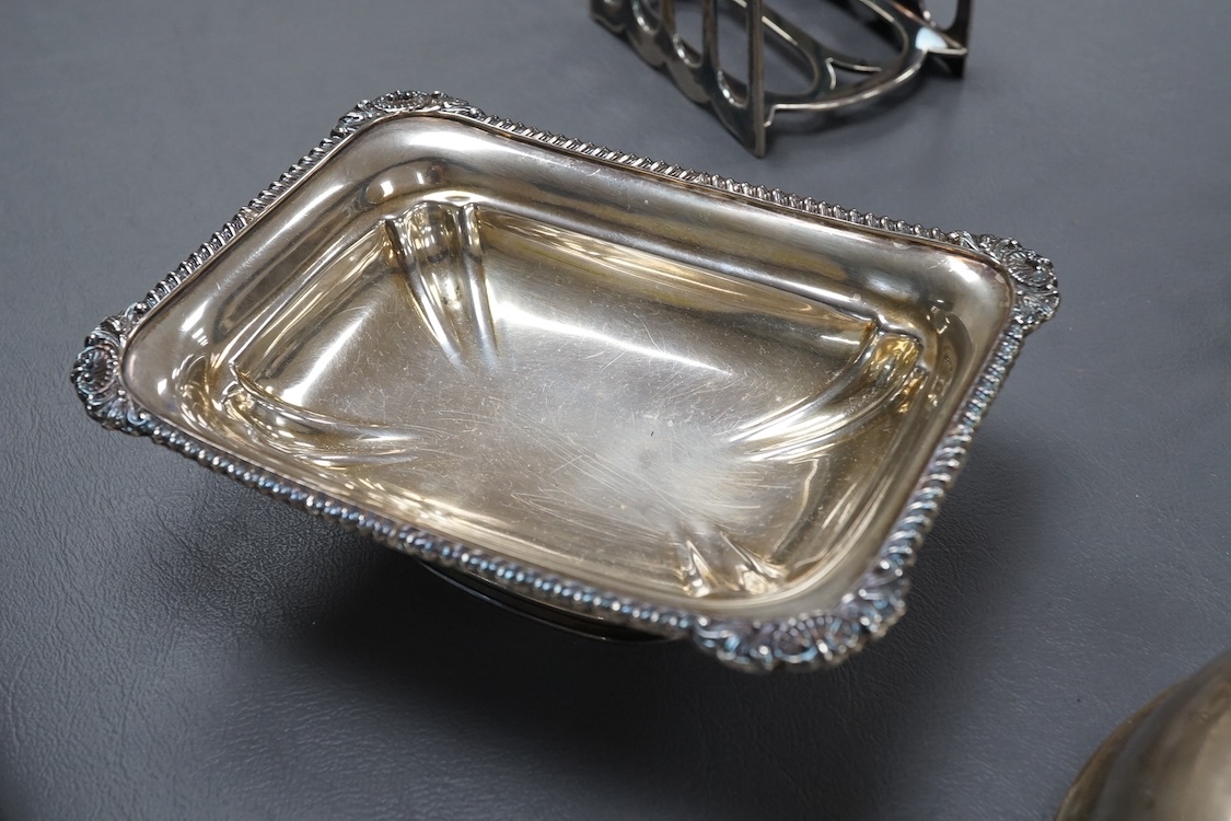 A pair of George V silver five bar toast racks, by Atkin Brothers, Sheffield, 1912, length 94mm, together with a silver muffin dish lid and a silver pedestal bonbon dish, 26.2ox